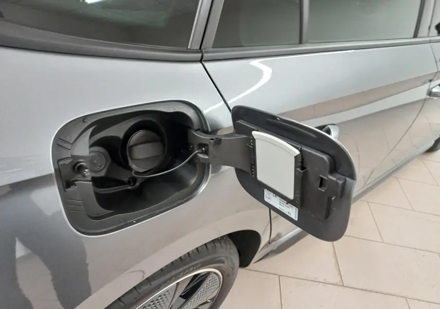 Gros plan sur la trappe à carburant ouverte côté gauche d'une Skoda Scala 2025 gris graphite métallisé.