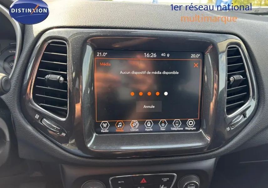 Écran tactile central du tableau de bord du Jeep Compass blanc 2021, avec commandes multimédia visibles.