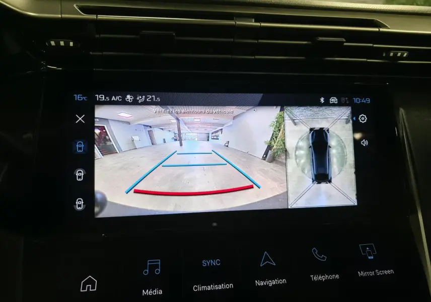 Écran tactile central de la Peugeot 408 gris montrant la caméra de recul et la vue 360° intérieure.