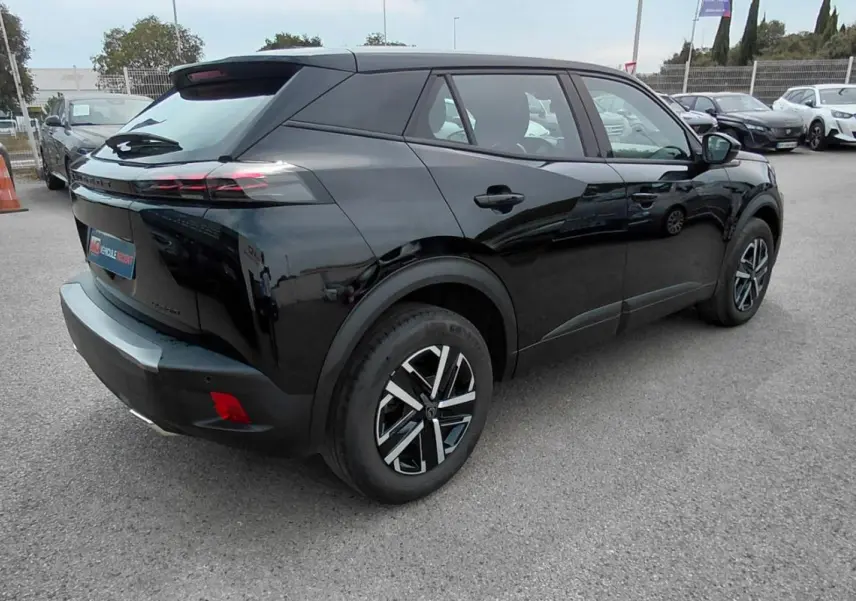 Vue 3/4 arrière droite d’un Peugeot 2008 Hybrid 145 noir 2025, soulignant ses feux arrière effilés et ses jantes modernes.
