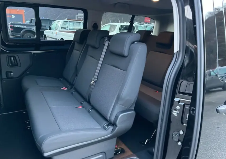 Vue intérieure côté droit du FIAT Scudo Fourgon noir 2025, montrant la banquette arrière 3 places et la porte latérale coulissante ouverte.