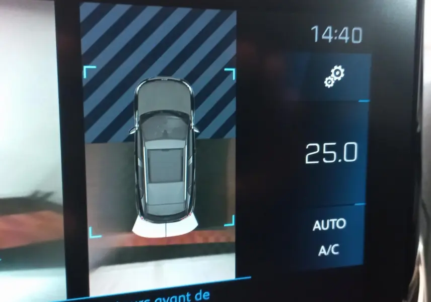 Affichage tactile intérieur montrant vue aérienne du Peugeot 2008 orange avec capteurs avant et réglage climatisation à 25°C.