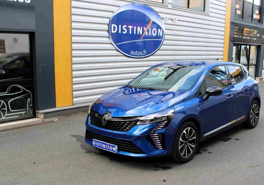 Renault Clio hybride bleu Iron Metal vue 3/4 avant droit, avec calandre noire et feux LED distinctifs.
