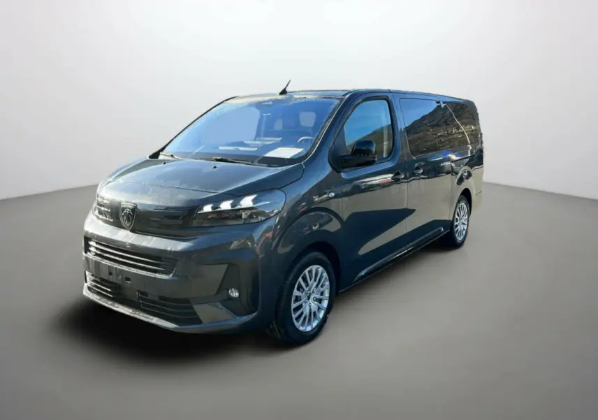 Peugeot Traveller gris titane en 3/4 avant droit, avec vitres surteintées et jantes tôle à enjoliveurs.