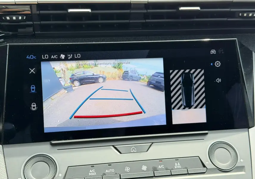 Écran tactile central montrant la caméra de recul et l’aide au stationnement du Peugeot 308 SW gris Selenium, vue intérieure.