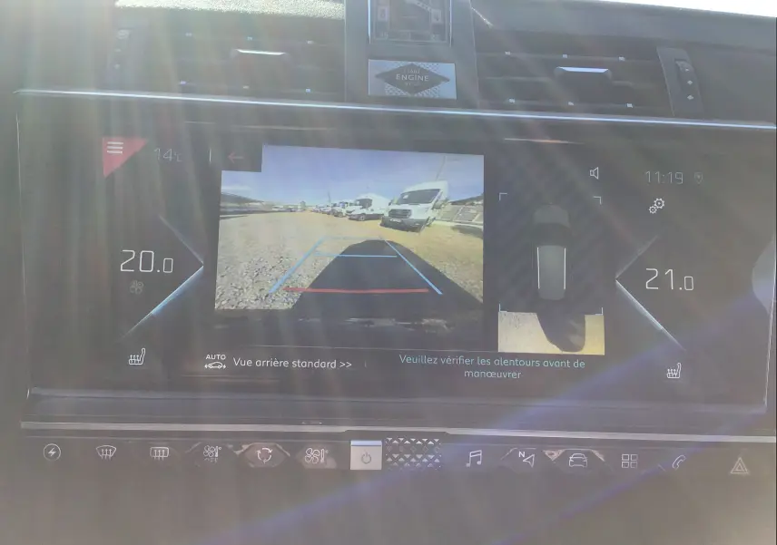 Écran tactile intérieur du DS7 Crossback noir montrant la caméra de recul avec affichage des températures à 20 et 21°C.