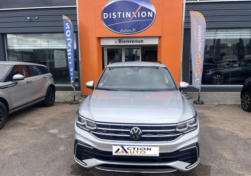 Vue avant d'un Volkswagen Tiguan 1.4 eHybrid gris dauphin métallisé, avec calandre R-Line et phares LED.