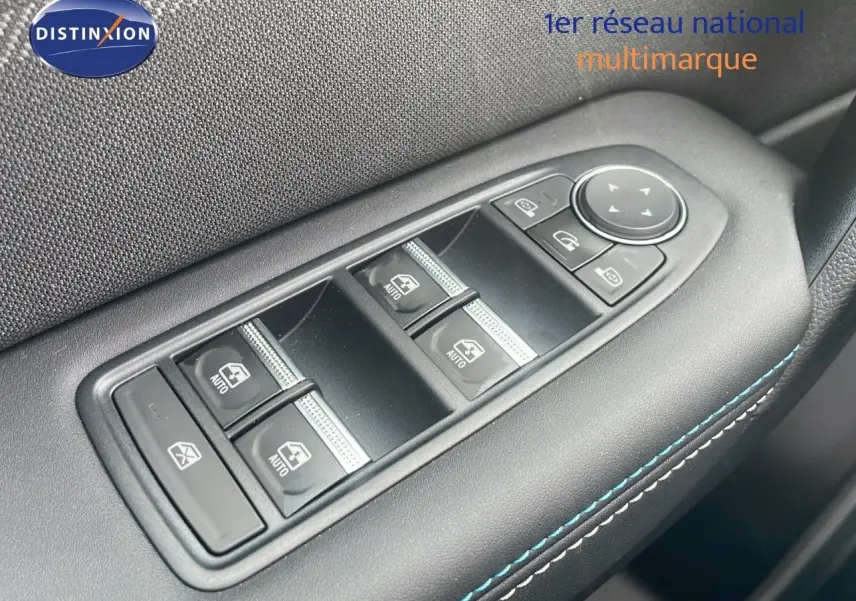 Gros plan sur les commandes des vitres électriques et rétroviseurs du côté conducteur du Renault Captur gris cassiopée toit noir.