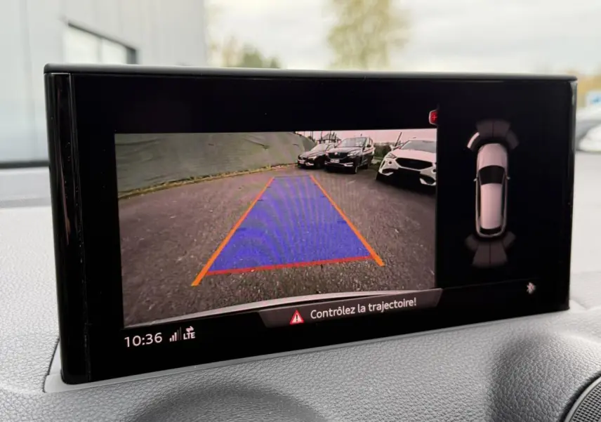 Affichage caméra de recul de l'Audi Q2 noir Mythe, avec guidage de trajectoire et vue 360° sur écran intérieur.
