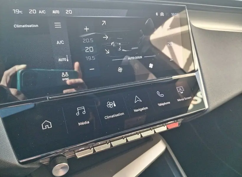 Écran tactile central du tableau de bord de la Peugeot 308 SW Hybrid 145, affichant les réglages de climatisation.