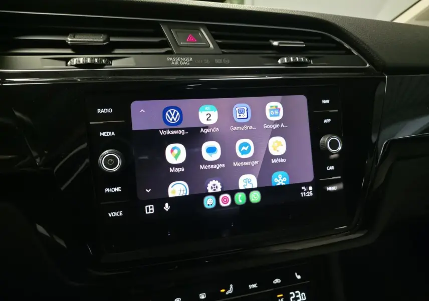 Écran tactile central du tableau de bord du Volkswagen Touran 2024, affichant des applications connectées.