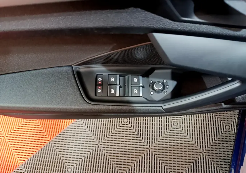 Panneau de commandes des vitres et rétroviseurs côté gauche intérieur d'une Audi A3 bleu 2023.