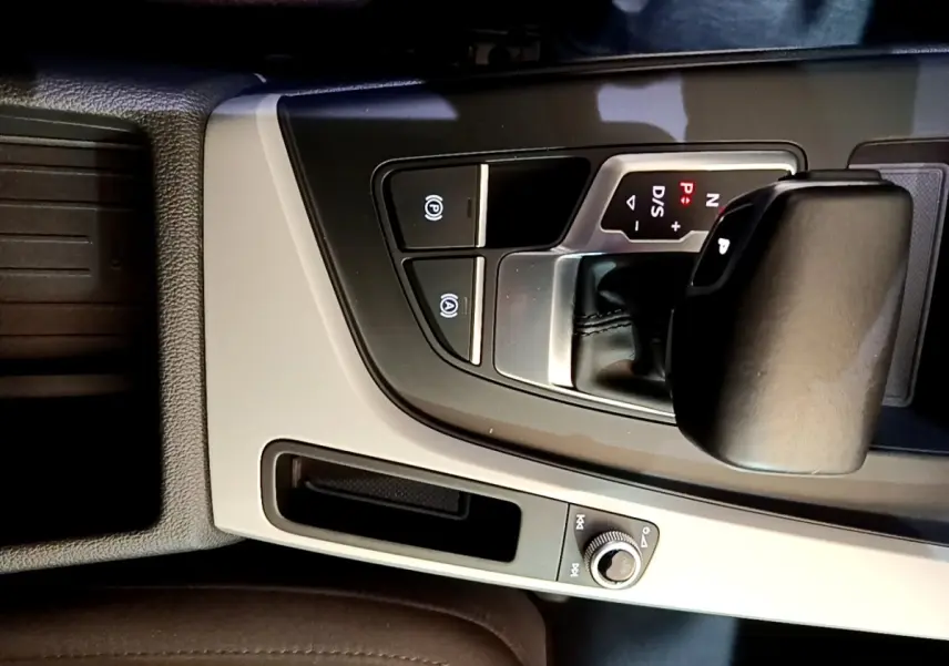 Vue rapprochée de la console centrale noire et grise avec levier de vitesse automatique de l'Audi A5 35 TFSI 2021.