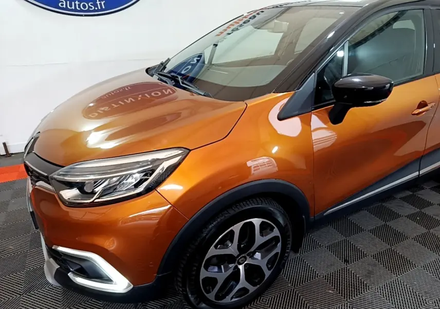 Vue 3/4 avant droit d'un Renault Captur Intens orange avec phares LED et jantes alliage distinctives.