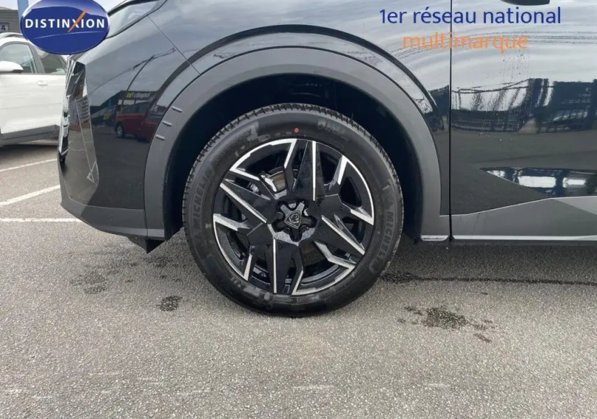 Gros plan sur la roue avant gauche noire du Peugeot 3008 1.2 Hybrid 145ch avec jante aluminium au design moderne.