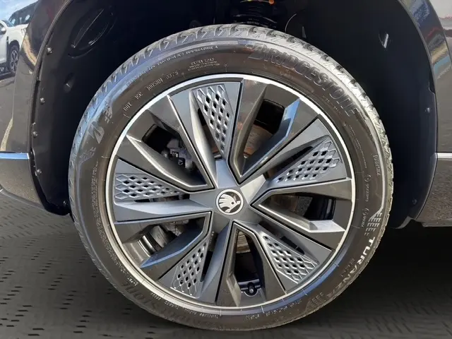 Gros plan sur la roue avant droite noire du Skoda Karoq 2.0 TDI 150ch avec jante alliage au design moderne.