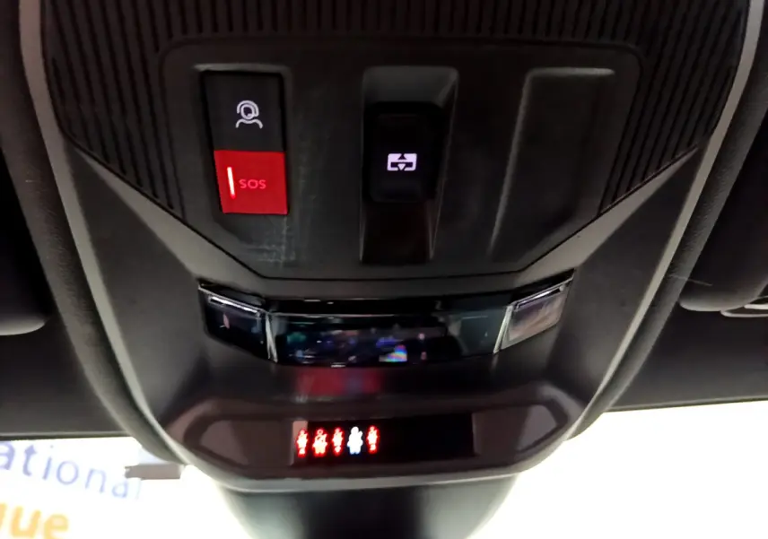 Vue en gros plan du plafonnier intérieur noir avec bouton SOS rouge et commande d'ouverture de toit sur Peugeot 308 PHEV blanc