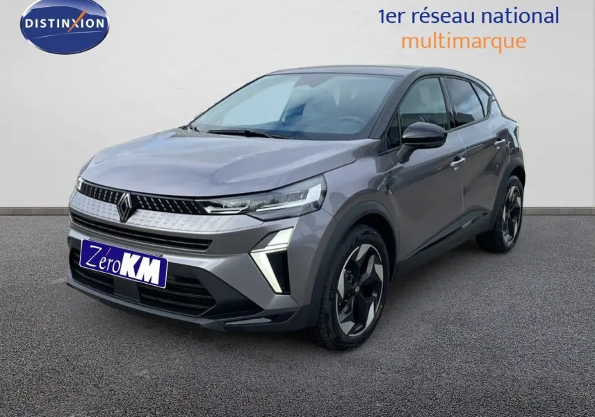 Renault Captur E-Tech gris Cassiopée métal avec toit noir, vue 3/4 avant droit soulignant ses feux LED et jantes biton.