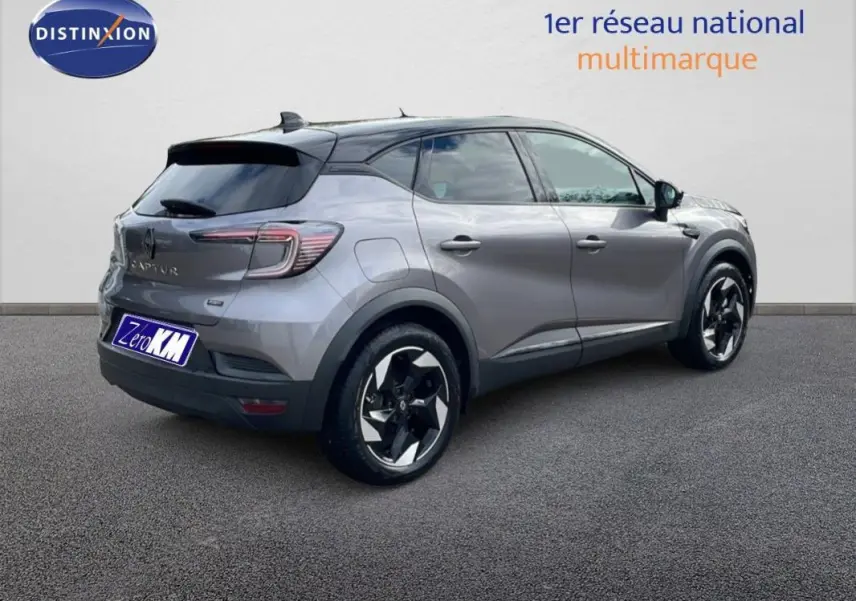 Renault Captur gris 3/4 arrière droit, jantes aluminium noires et toit noir contrasté visible.