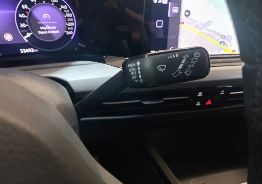 Gros plan sur la commande d’essuie-glace à gauche du volant dans le tableau de bord numérique de la Volkswagen Golf bleue 2022.