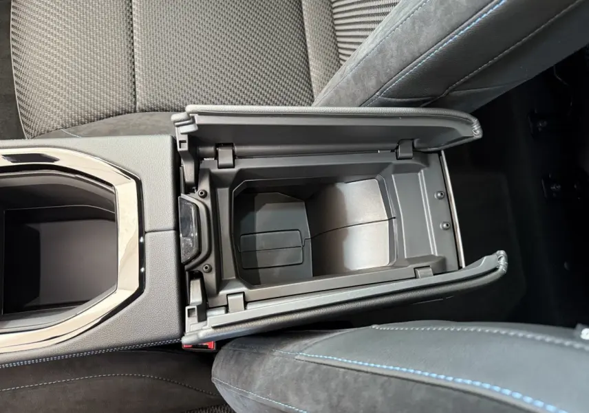 Vue plongeante sur le rangement central ouvert en cuir noir avec surpiqûres bleues du Renault Espace gris foncé esprit Alpine 2025.