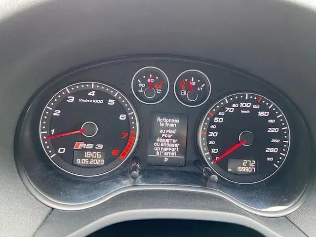 Tableau de bord de l'Audi RS3 Sportback gris Daytona, affichant compte-tours, vitesse et message de démarrage.