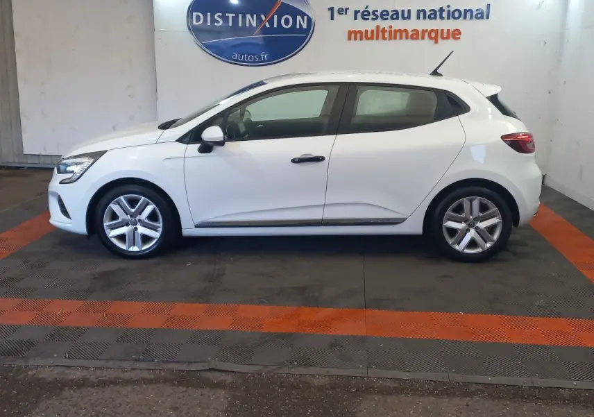 Profil droit d'une Renault Clio Business blanche 2021, avec jantes alliage et poignées de porte noires visibles.
