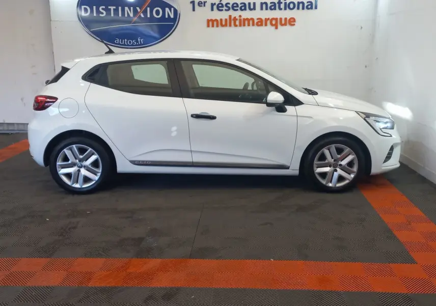 Profil côté gauche d'une Renault Clio Business blanche de 2021, avec jantes alliage et feux arrière LED visibles.