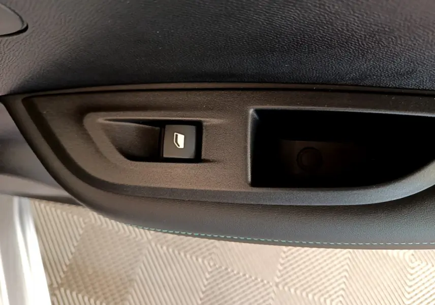 Bouton de commande de lève-vitre sur la porte intérieure, tissu noir, Peugeot 2008 gris clair 2021.