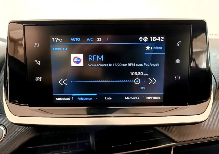 Écran tactile central affichant la radio RFM dans l'habitacle noir du Peugeot 2008 PureTech 130 Allure 2022.