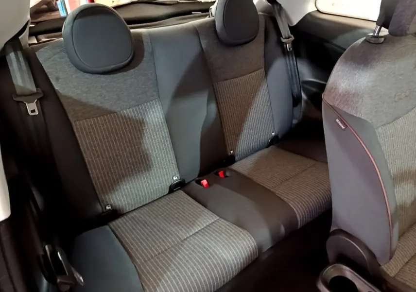 Vue intérieure de la banquette arrière grise et noire de la Fiat 500 42kWh Icône 2022 avec appuie-têtes ronds.