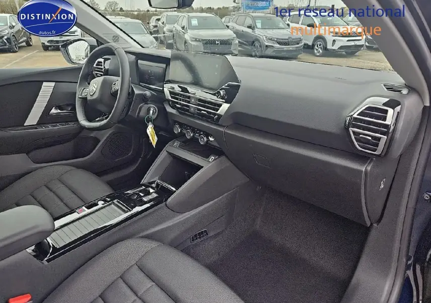 Vue intérieure côté passager de la Citroën C4 1.2 hybride 145 plus bleu eclipse, avec tableau de bord et console centrale noire.