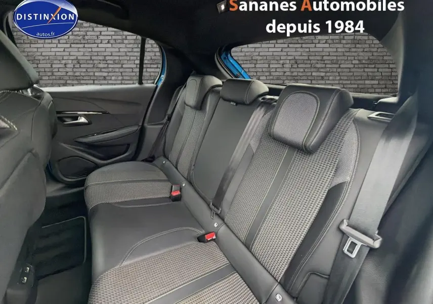 Vue intérieure arrière de la Peugeot 208 GT Line 2020, montrant la banquette noire avec surpiqûres vertes et ceintures de sécurité.