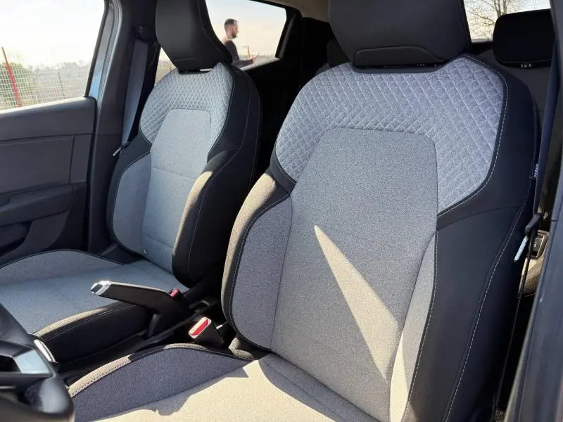 Vue rapprochée des sièges avant gris clair et noir de la Renault Clio 1.0 TCe 90ch Evolution 2025.