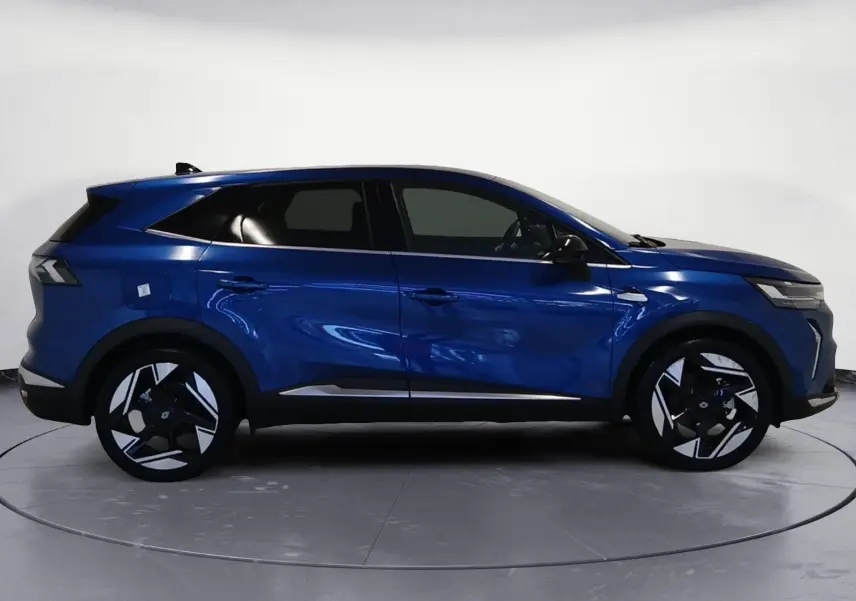 Profil droit du Renault Symbioz E-Tech Full Hybrid 145 Iconic 2025 en bleu iron avec jantes noires et argentées.