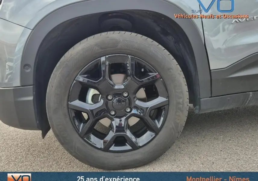 Gros plan sur la roue avant droite noire brillante du Jeep Avenger gris foncé 2024 finition Altitude