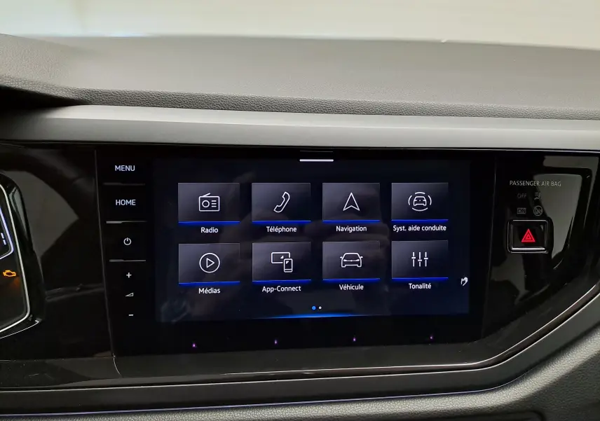 Écran tactile central du tableau de bord du Volkswagen Taigo 1.5 TSI noir, affichant le menu multimédia et navigation.