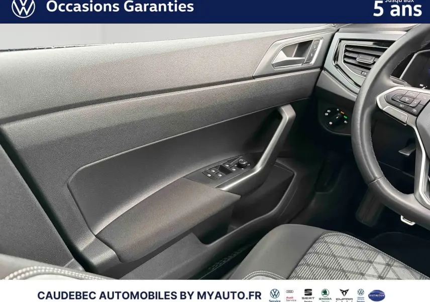 Vue intérieure côté conducteur de la Volkswagen Polo 2025, montrant la portière noire et le volant cuir multifonctions.