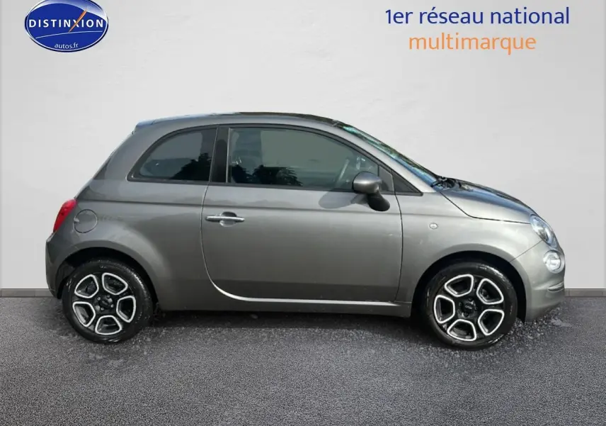 Profil droit d'une Fiat 500 gris métallisé 2022 avec jantes alliage et poignées de porte chromées.