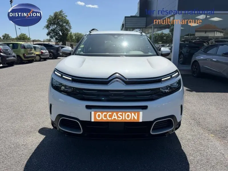 Vue frontale d'un Citroën C5 Aircross gris clair avec calandre noire et feux LED distinctifs.