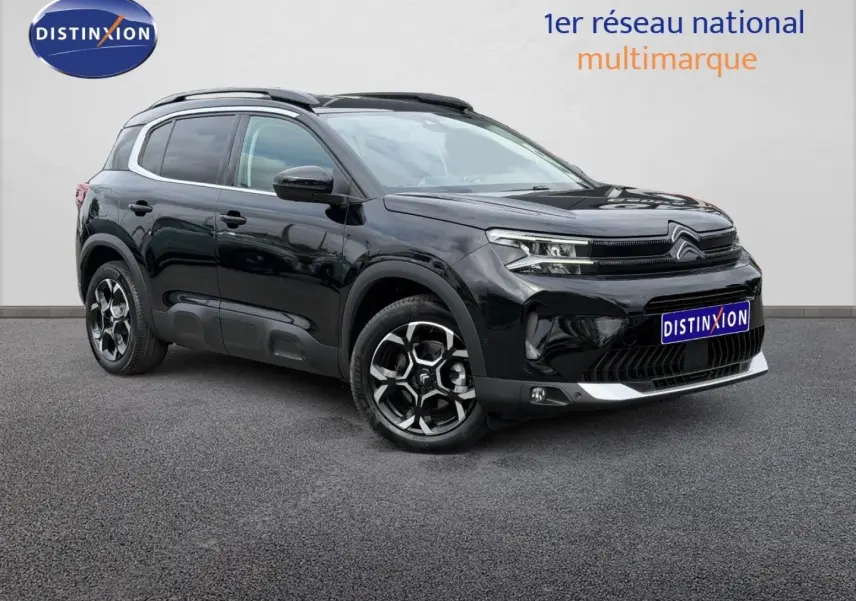 Citroën C5 Aircross noir Perla Nera vue 3/4 avant droit avec jantes alu et barres de toit visibles.