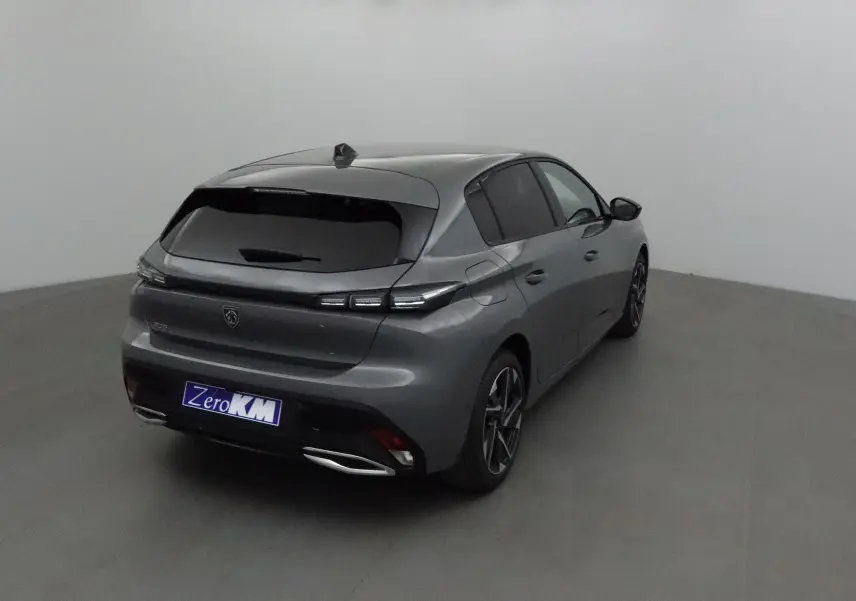 Peugeot 308 gris selenium vue 3/4 arrière droit dans un studio, avec vitres teintées et jantes alliage.