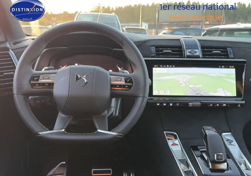 Vue intérieure centrée sur le volant cuir DS et l'écran tactile large du tableau de bord du DS7 noir.