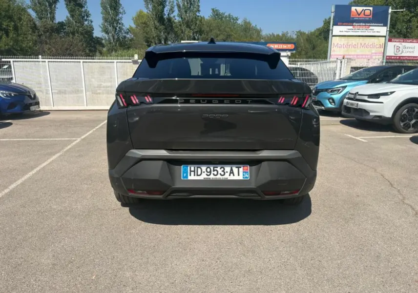 Vue arrière d’un Peugeot 3008 gris 2025 avec feux arrière à griffes rouges et plaque d’immatriculation française.