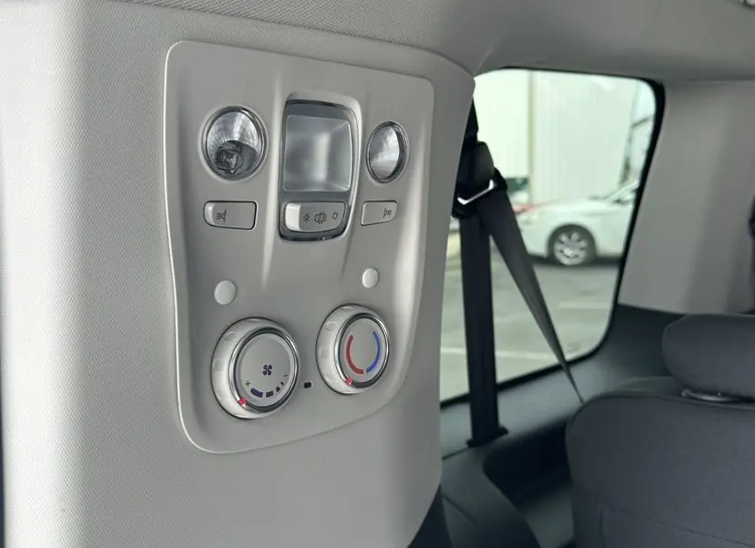 Vue intérieure arrière droite du Citroën Jumpy van blanc, panneau de commandes climatisation et éclairage au plafond.