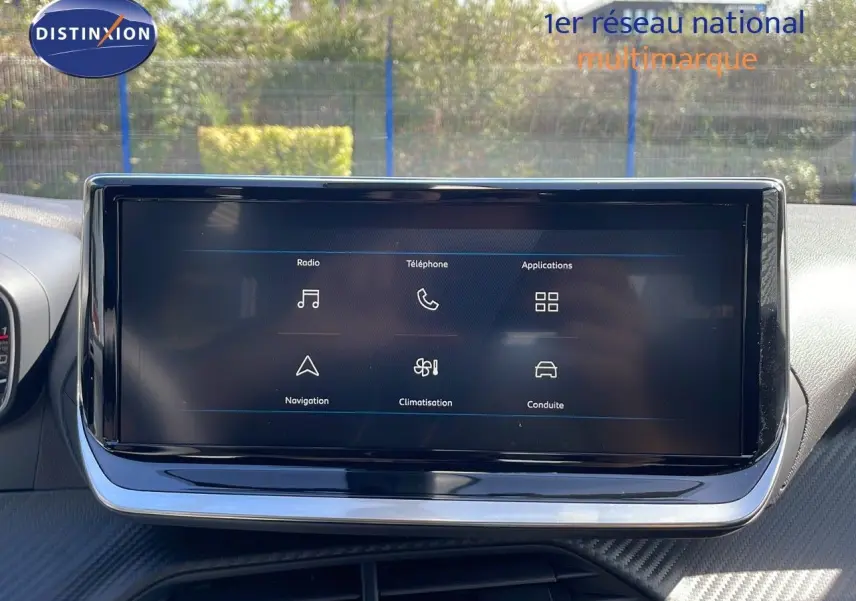 Écran tactile central du tableau de bord du Peugeot 2008 2025, affichant les menus radio, téléphone et navigation.