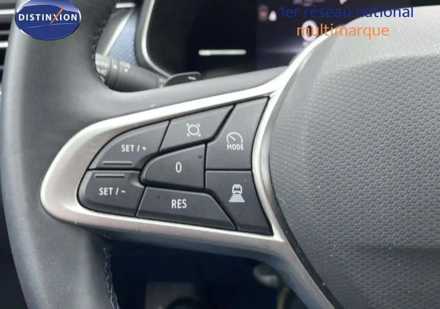 Gros plan sur les commandes de régulateur de vitesse au volant d'une Renault Arkana 2025, bleu Zanzibar metal.