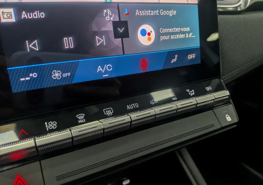 Gros plan sur la console centrale tactile du Renault Symbioz gris Rafale, affichant les commandes climatisation et assistant Google.