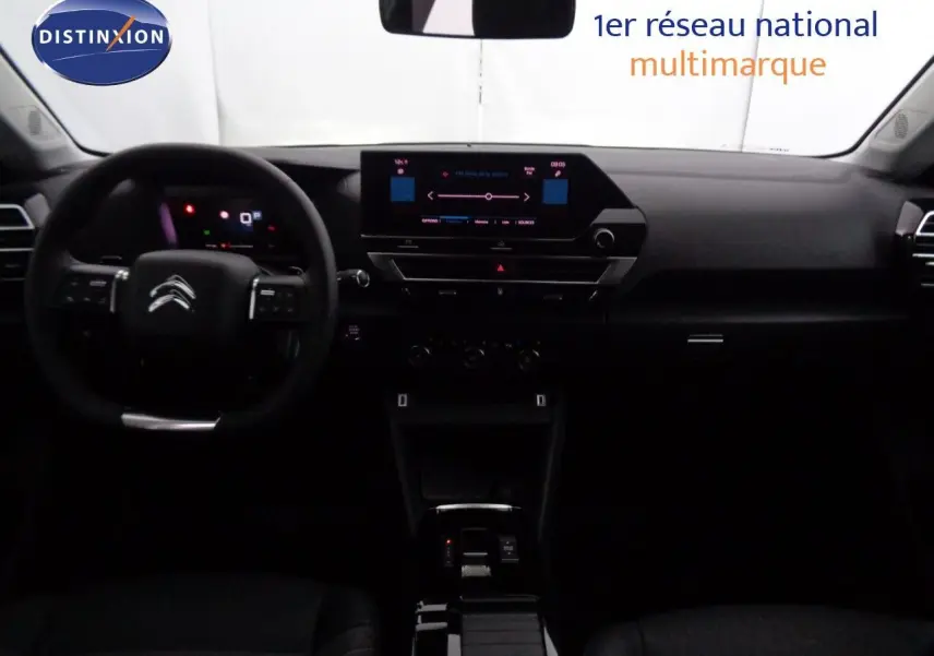 Vue intérieure avant du tableau de bord et volant de la Citroën C4 2023 avec écran tactile et finition noire.