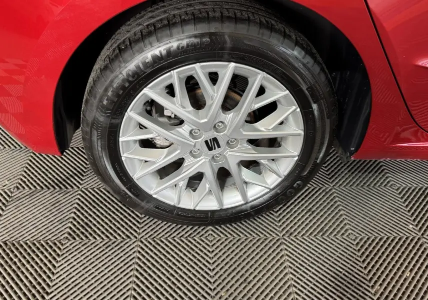 Gros plan sur la roue avant droite avec jante argentée et carrosserie rouge vif d'une SEAT Ibiza 2024.